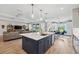 Open concept kitchen with island, modern cabinetry, and stainless steel appliances at 19907 Tattnall Way, Brooksville, FL 34601