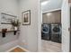 Laundry room with washer, dryer, and upper cabinets at 19907 Tattnall Way, Brooksville, FL 34601