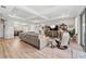 Bright living room with hardwood floors and large sectional sofa at 19907 Tattnall Way, Brooksville, FL 34601