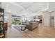 Spacious living room with hardwood floors and access to backyard at 19907 Tattnall Way, Brooksville, FL 34601