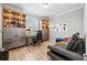 Home office with built-in shelving and a comfortable sofa at 19907 Tattnall Way, Brooksville, FL 34601