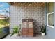 Covered patio with built-in grill and patterned tile feature wall at 19907 Tattnall Way, Brooksville, FL 34601
