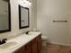 Bathroom with double vanity, mirror, and tiled floor at 21242 Diamonte Dr, Land O Lakes, FL 34637