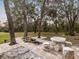 Elegant outdoor patio with stone furniture and fire pit at 21340 Powell Rd, Brooksville, FL 34604