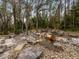 Serene backyard water feature with stonework and lighting at 21340 Powell Rd, Brooksville, FL 34604