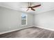 Bright bedroom with ceiling fan, large window and wood-style flooring at 2468 Magellan Ave, Spring Hill, FL 34608