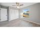 Bright bedroom with wood-look floors, large window, and ample closet space at 3351 Lambert Ave, Spring Hill, FL 34608