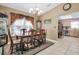 Dining room with a view into kitchen, chandelier and hutch at 4554 Whitetail Ln, New Port Richey, FL 34653