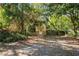 Quaint house nestled among lush trees, featuring a stone accent and a white front door at 4780 69Th N St, St Petersburg, FL 33709