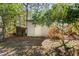 Small, light-colored storage shed in wooded area at 4780 69Th N St, St Petersburg, FL 33709