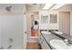 Bathroom with double vanity and a view of the kitchen at 5216 Frost Rd, Spring Hill, FL 34606