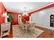 Formal dining room showcasing red walls and hardwood floors at 6128 Evening Ray Dr, Brooksville, FL 34601