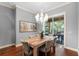 Bright dining room with hardwood floors and a chandelier, leading to a patio at 6128 Evening Ray Dr, Brooksville, FL 34601