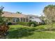 House with a large screened patio and green lawn at 6604 Rosemont Ct, New Port Richey, FL 34655