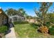 Screened patio and lush lawn with manicured hedges at 6604 Rosemont Ct, New Port Richey, FL 34655