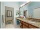 Bathroom with dual sinks, granite countertops and large mirror at 6604 Rosemont Ct, New Port Richey, FL 34655
