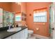 Small bathroom with shower/tub combo and peach colored walls at 6604 Rosemont Ct, New Port Richey, FL 34655