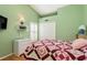 Guest bedroom with a double bed and light green walls at 6604 Rosemont Ct, New Port Richey, FL 34655