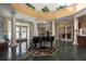 Elegant clubhouse lobby with a grand piano and high ceilings at 6604 Rosemont Ct, New Port Richey, FL 34655