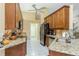 Modern kitchen with granite countertops and stainless steel appliances at 6604 Rosemont Ct, New Port Richey, FL 34655