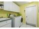 Laundry room with washer, dryer, and cabinets at 6604 Rosemont Ct, New Port Richey, FL 34655