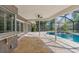 Inviting pool area with covered patio and lush landscaping at 939 Woodland Dr, Palm Harbor, FL 34683