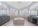Double vanity bathroom with a large soaking tub at 10307 Ridge Top Loop, Weeki Wachee, FL 34613