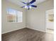 Bedroom with wood-look floors, ceiling fan, and exterior access at 10307 Ridge Top Loop, Weeki Wachee, FL 34613