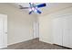 Bedroom with wood-look floors, double door closet, and ceiling fan at 10307 Ridge Top Loop, Weeki Wachee, FL 34613