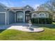 House entrance with stone accents, double doors, and a fountain at 10307 Ridge Top Loop, Weeki Wachee, FL 34613