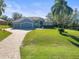 Two-story house with gray siding, stone accents, and a paved driveway at 10307 Ridge Top Loop, Weeki Wachee, FL 34613