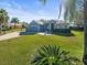 House with gray siding, stone accents, and a landscaped lawn at 10307 Ridge Top Loop, Weeki Wachee, FL 34613