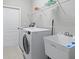 Laundry room with washer, dryer, shelving and utility sink at 10307 Ridge Top Loop, Weeki Wachee, FL 34613