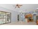 Bright living room with sliding doors to pool area and kitchen views at 10307 Ridge Top Loop, Weeki Wachee, FL 34613