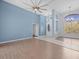 Living room with wood-look floors and a view of entryway and backyard at 10307 Ridge Top Loop, Weeki Wachee, FL 34613
