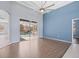 Living area with wood-look floors, a ceiling fan, and access to the pool at 10307 Ridge Top Loop, Weeki Wachee, FL 34613