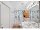 Simple bathroom with single sink, shower/tub combo, and a leaf-patterned shower curtain at 10514 Salisbury St, Riverview, FL 33569