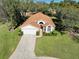 Bird's eye view of a single-story house with a brown roof and a driveway at 11445 Deercroft Ct, Spring Hill, FL 34609