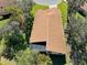 Top-down view of a house showcasing its roofline and screened enclosure at 11445 Deercroft Ct, Spring Hill, FL 34609