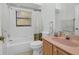 Updated bathroom with pink vanity and bathtub at 11445 Deercroft Ct, Spring Hill, FL 34609