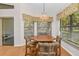 Bright breakfast nook with wood table and chairs by a window at 11445 Deercroft Ct, Spring Hill, FL 34609
