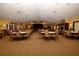 Large community room with ample seating and hardwood floors at 11445 Deercroft Ct, Spring Hill, FL 34609