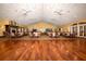 Large community room with hardwood floors and multiple tables at 11445 Deercroft Ct, Spring Hill, FL 34609