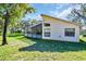 Single-story house with a screened patio and well-maintained lawn at 11445 Deercroft Ct, Spring Hill, FL 34609