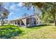 Rear exterior view of house and yard at 11445 Deercroft Ct, Spring Hill, FL 34609