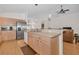 Open kitchen features a breakfast bar and stainless steel refrigerator at 11445 Deercroft Ct, Spring Hill, FL 34609