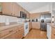 Bright kitchen with stainless steel appliances and light wood cabinets at 11445 Deercroft Ct, Spring Hill, FL 34609