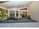 Spacious screened patio with table and chairs, offering relaxing outdoor space at 11445 Deercroft Ct, Spring Hill, FL 34609