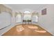 Bright sunroom featuring three arched windows and wood flooring at 11445 Deercroft Ct, Spring Hill, FL 34609