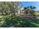 Landscaped backyard with lush grass and palm trees at 11544 Mcleod St, Spring Hill, FL 34609